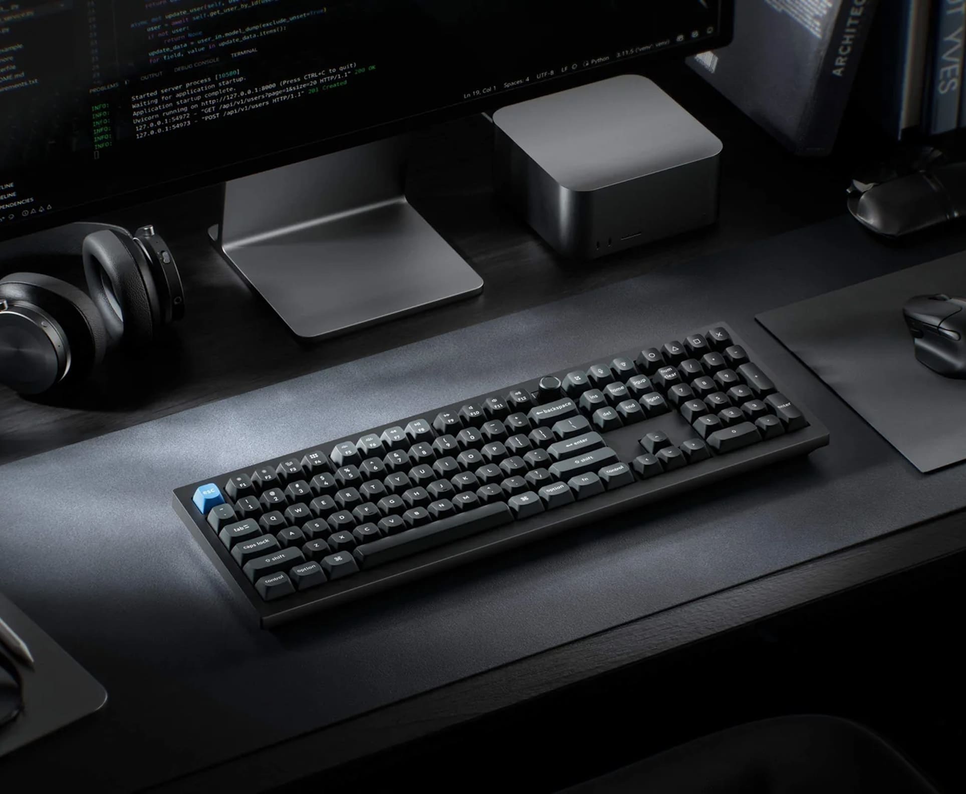 Close up of mechanical keyboard, high-refresh rate monitor, and computer diagnostic tools in a lab
